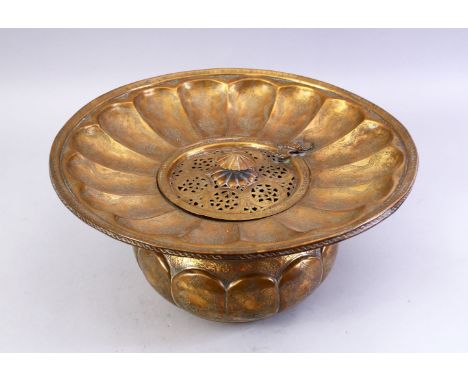 A GOOD LARGE 18TH/19TH CENTURY PERSIAN ENGRAVED BRASS BASIN, the centre with a hinged pierced cover, 37cm diameter.