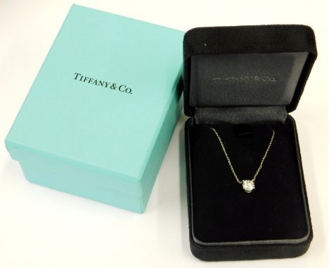 A Tiffany & Co solitaire diamond and platinum pendant, with a four claw set brilliant cut diamond of 0.77 carats, F colour, V
