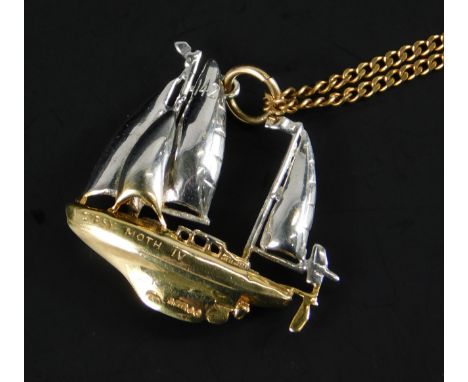 A 9ct gold boat pendant and chain, the boat in bi-colour design bearing number 142 to sail and Gypsy Moth IV to boat, on a fi