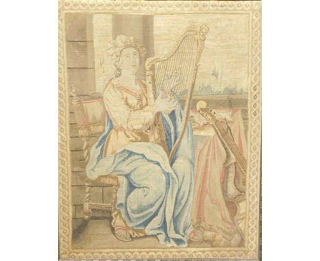 A late 18th/early 19thC Savonnerie tapestry panel, depicting a lady playing a harp, whilst seated beside a window, within a d