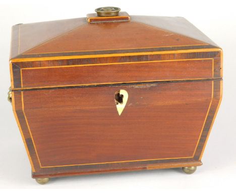 A George III mahogany and boxwood strung tea caddy, of sarcophagus form on bun feet. 