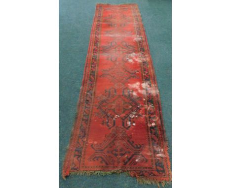 A Victorian Turkey pattern carpet runner, on a red ground, 355cm x 98cm.