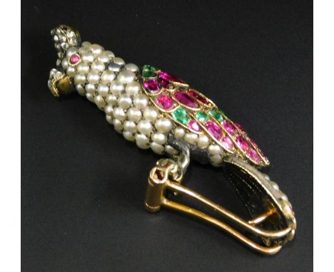 A Victorian bird brooch, set with seed pearls, rubies, emeralds and diamonds, in the form of a parakeet, the body formed of s