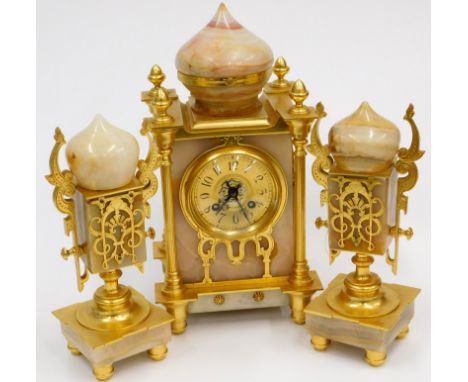 A 19thC French pink variegated marble mantel clock garniture in the Persian style, the clock with a central dome, surrounded 