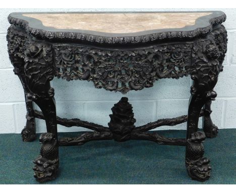 A 19thC Chinese carved hardwood console table, with floral and dragon decoration, inset marble top, 130cm wide.