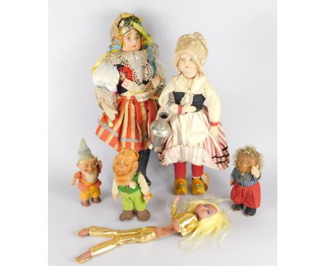A collection of early to mid 20thC costume dolls, to include a Flemish girl carrying a flagon, wearing painted wooden clogs, 