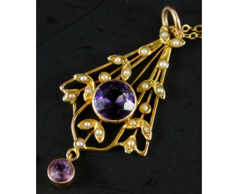 An Art Nouveau pendant and chain, the pendant set with central amethyst, surrounded in a floral drape with seed pearls and an