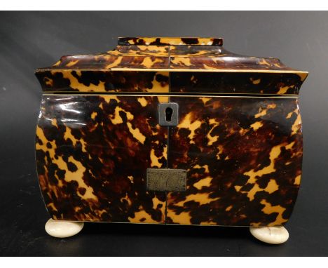 A Regency tortoiseshell tea caddy, the sarcophagus shaped lid, velvet lined and hinging to reveal a two sectional compartment