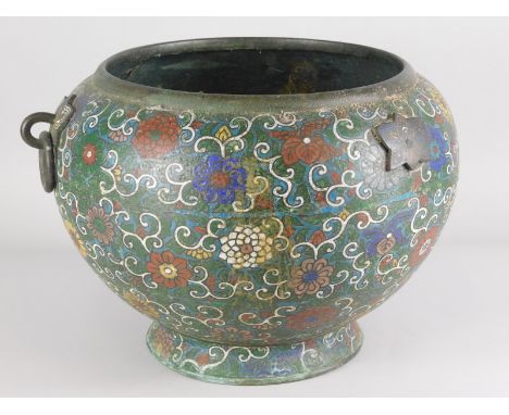 A late 19thC Chinese champlevé enamel jardiniere, decorated overall with flowers, scrolls etc., 36cm wide. (AF)
