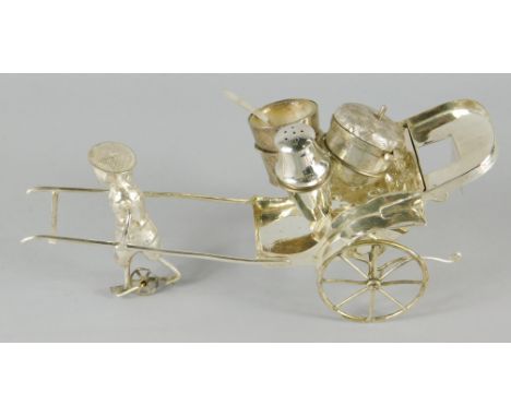 An Eastern white metal cruet model, in the form of a rickshaw