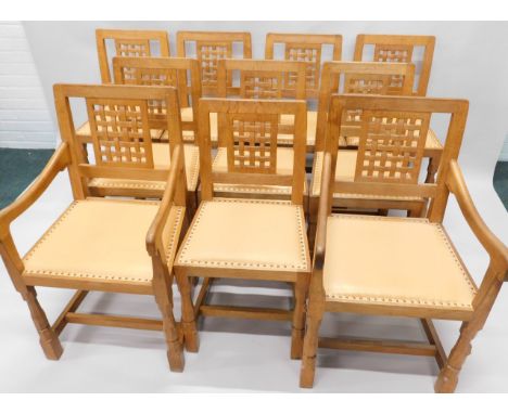 A set of ten Robert Thompson of Kilburn 'Mouseman' oak dining chairs, each with a lattice back, a pale brown leather seat, on