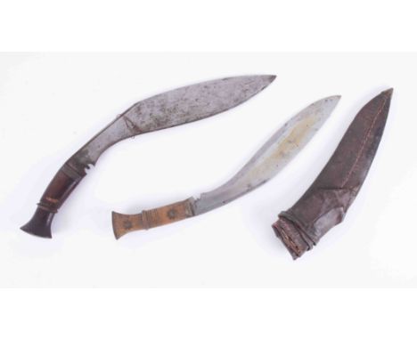 A Kukri knife and another with leather scabbard (2).We are sorry but Plymouth Auction Rooms are unable to provide an in-house