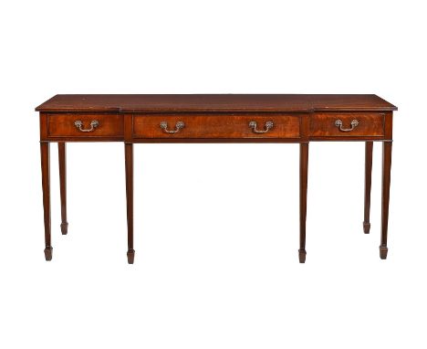A modern reproduction three drawer side table, of breakfront form, on square tapering legs and spade feet, 182cms wide, 84.5c