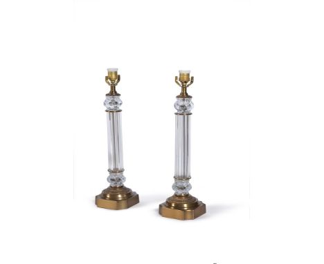 A pair of gilt metal and moulded glass columnar table lamps, modern, the twist-lobed capitals above reeded stems descending t