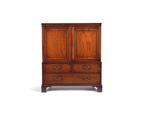 A George III mahogany low linen press, the rectangular moulded top above a pair of panelled doors now enclosing a void interi