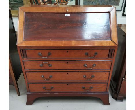 A mahogany reproduction fall front bureau with fitted interior and 4 drawers, on bracket feet 