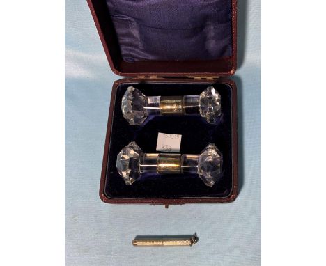 A pair of silver mounted carver rests, London 1929, cased; a silver toothpick, cased; a travelling inkwell 