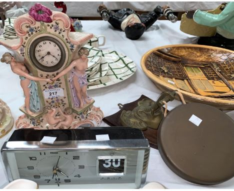 A continental porcelain figural clock; a mantel clock; a dinner gong 