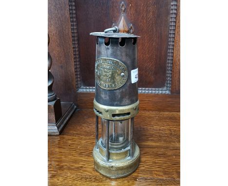 A brass miners' lamp by Thomas &amp; Williams; 2 Geldart prints 