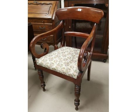 A early 19th century mahogany carver chair with scroll arms and floral tapestry seat 