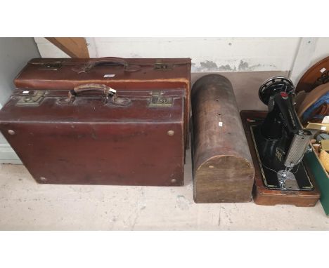 A Singer hand operated sewing machine, 2 vintage leather suitcases 