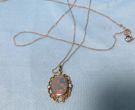 A 9 carat hallmarked gold pendant set with an opal coloured stone and simulated diamonds, on silver chain, pendant 2.6 gm 