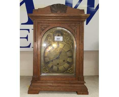 An Edwardian chiming mantel clock in oak case with arched brass dial, height 17" 