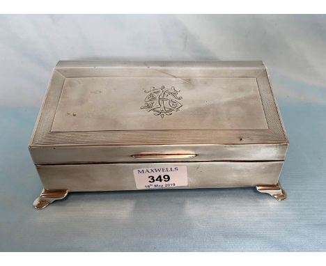 A silver cigarette box, engine turned with slope front, monogrammed, London 1924 