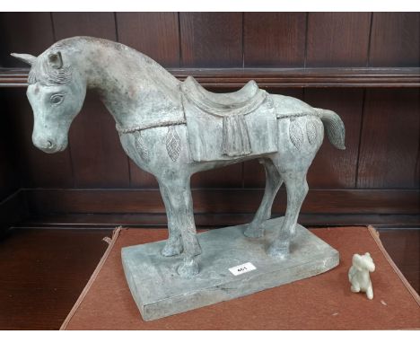 A Tang style patinated metal horse on rectangular base; a recumbent goat in jade coloured soapstone 