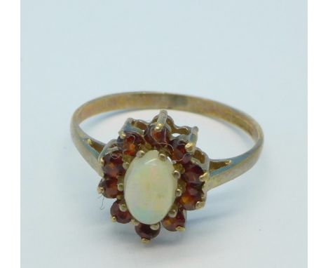 A 9ct gold, opal and red stone ring, 1.3g, K