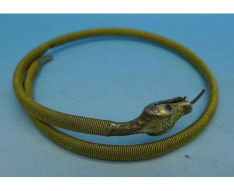 A vintage 9ct gold snake bangle with ruby eyes, 14.1g