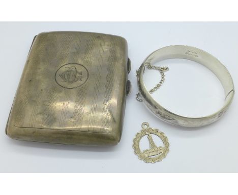 A silver cigarette case, a silver bangle and a silver pendant, 93g