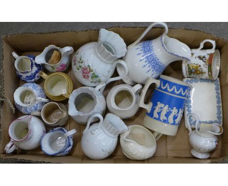 A Royal Worcester Willow pattern cream jug, a Wedgwood jug, a set of three graduated jugs, etc.
