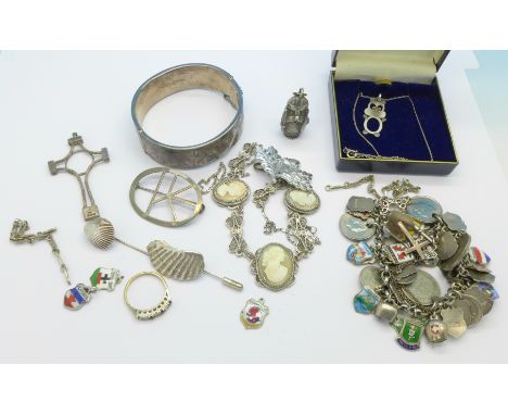 A silver bangle, silver and enamel charm bracelet with some metal coin charms, other silver jewellery, etc.