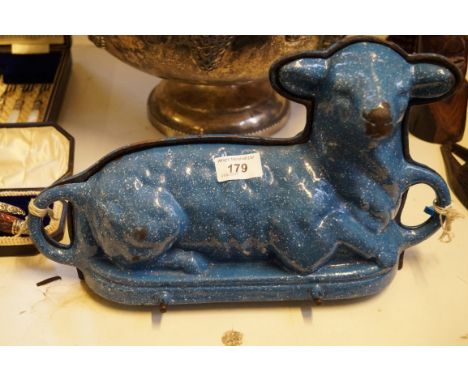 A vintage blue enamel mould in the form of a seated lamb.