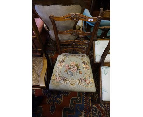 A late 19th Century ladder back single chair with tapestry cushion seat.