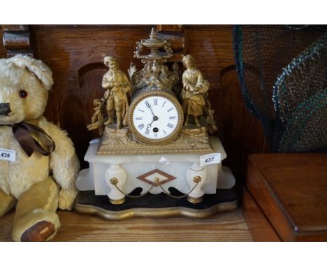An early 20th Century gilt spelter figural mantel clock with white enamel dial raised on alabaster base.