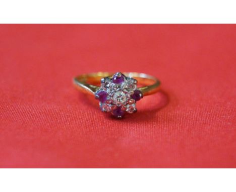 A ruby and diamond cluster ring, to an 18ct gold shank, weight 3g