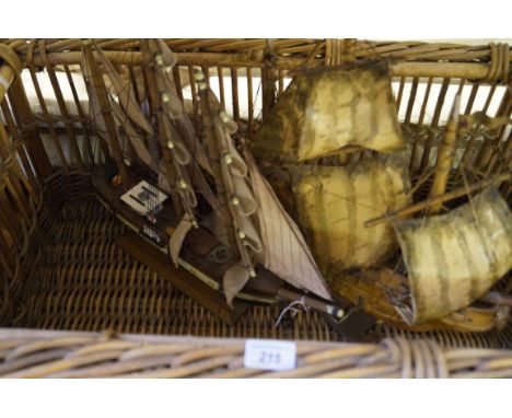A large vintage twin handled wicker basket, together with two modern models of boats.