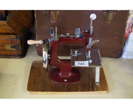 A vintage childrens sewing machine fitted in original carry case.