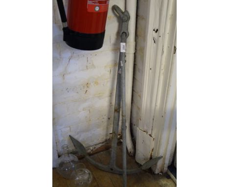 A vintage grey painted ships anchor.