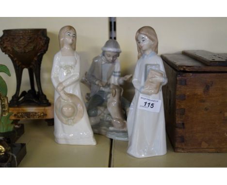 A Nao figure depicting a boy seated with puppy together with two Spanish figurines.