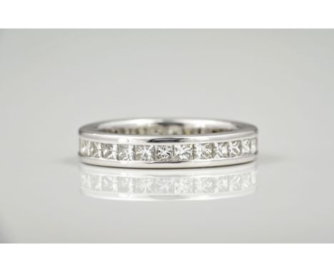 An 18ct white gold and diamond full eternity ring, channel set with twenty eight princess cut diamonds, good clarity and colo