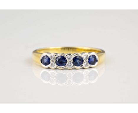 An 18ct yellow gold, sapphire and diamond ring, the four round cut sapphires divided by pairs of brilliant cut diamonds, all 