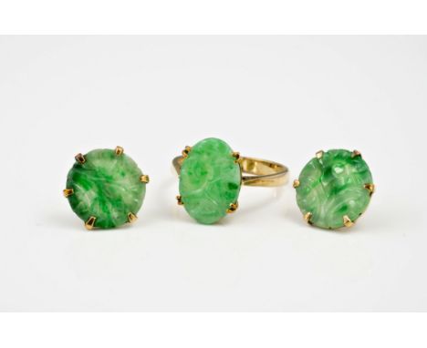 A pair of 9ct gold and Chinese carved jade stud earrings, the circular mottled apple green and celadon jade with floral carvi