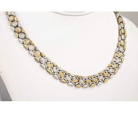 A two colour 9ct gold bark effect necklace, import hallmarks for London 1976, the tapered necklace with bark effect hexagonal