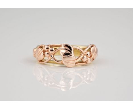 A Clogau Welsh 9ct yellow and rose gold openwork ring, with pierced, meandering foliate and berry decoration, ring size N½.