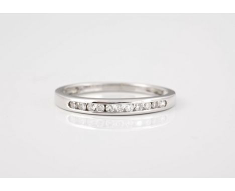 A 9ct white gold and diamond half eternity ring, channel with brilliant cut diamonds, size N.