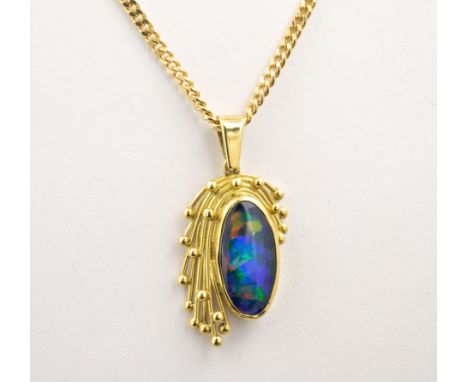 An 18ct gold and synthetic opal pendant and matching ring, the pendant and ring with an elliptical cabochon synthetic opal wi