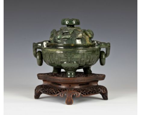 A Chinese finely carved spinach-green jade tripod censer and cover, Qianlong style, the censer in deep green tone mottled wit
